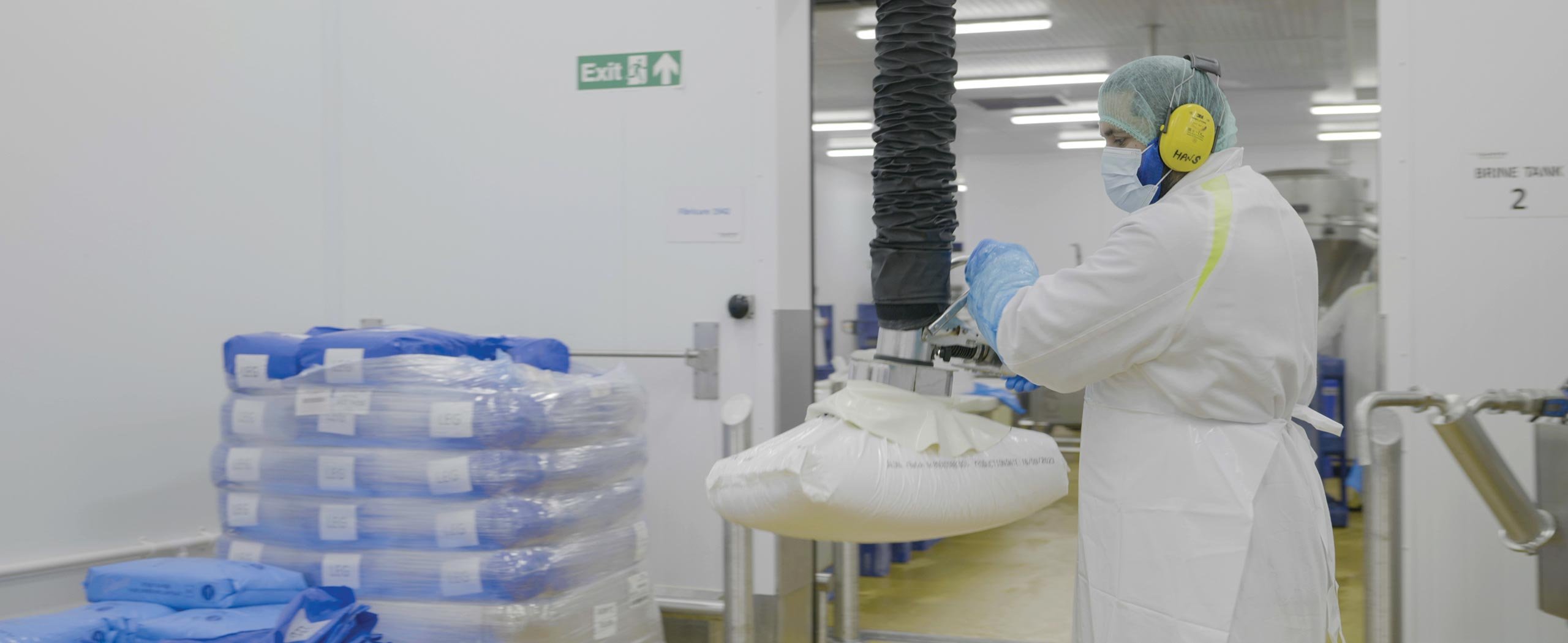 Man in food production using stainless steel vacuum lifter for bag handling