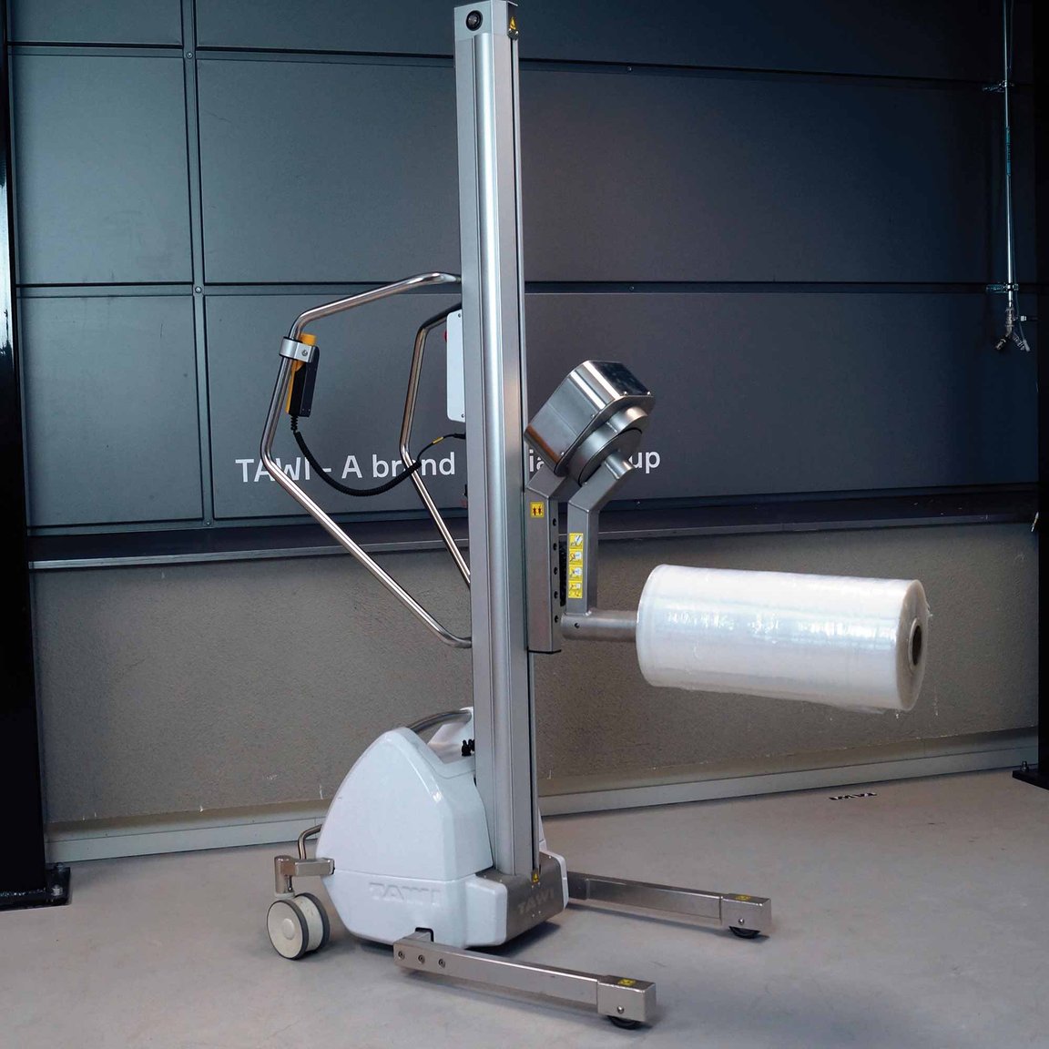 TAWI roll lifter in action on the warehouse floor. Effortlessly lifting cumbersome rolls/reels.