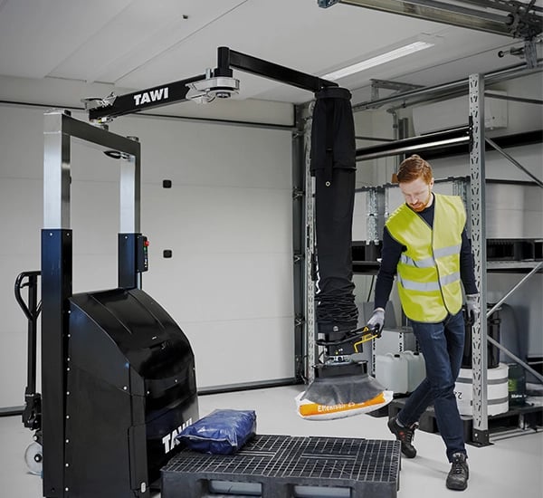 TAWI bag lifter in action on the warehouse floor. Effortlessly lifting cumbersome bags.