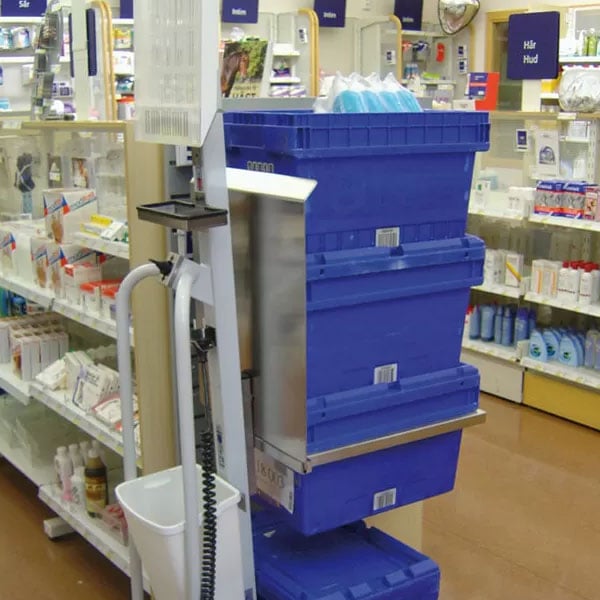 Multiple Crates being lifted and supported by an attachment on an ergonomic electric lift assist