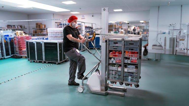 A person uses a TAWI trolley to move an airline trolley