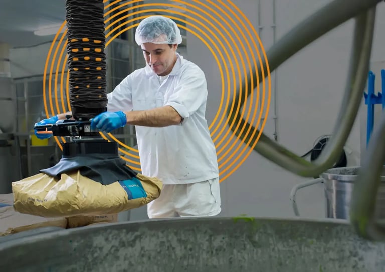 Operator using a vacuum lifter to lift bags in food production industry