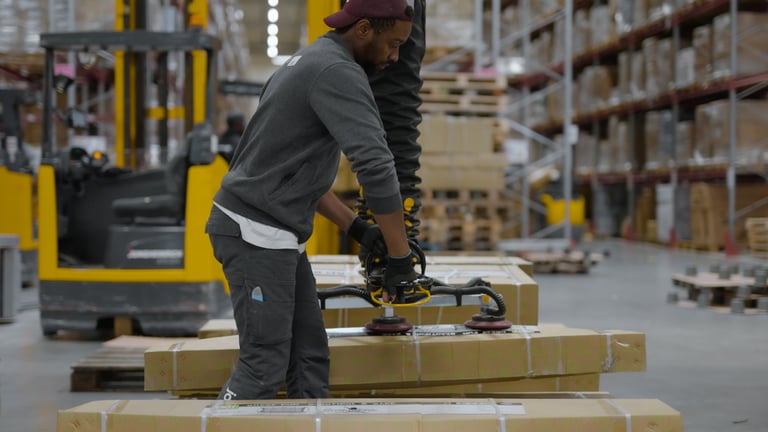 Box lifting at Jollyroom warehouse with TAWI Multifuncitonal lifter