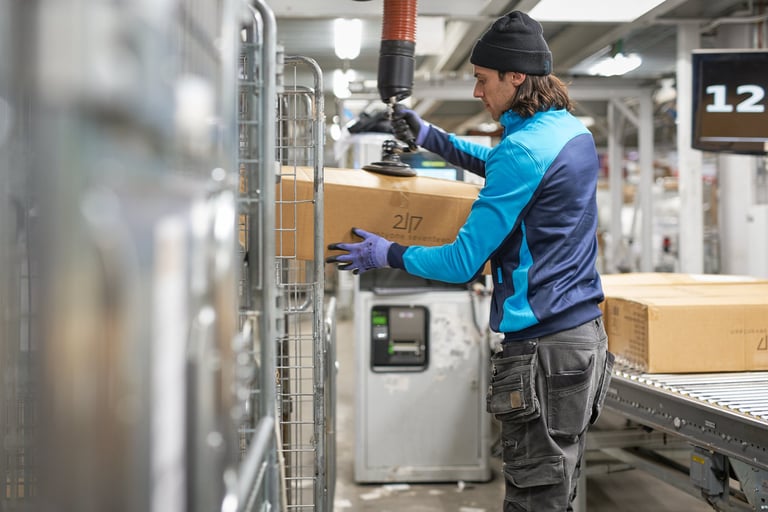 Man handling packages at Postnord Logistic Center