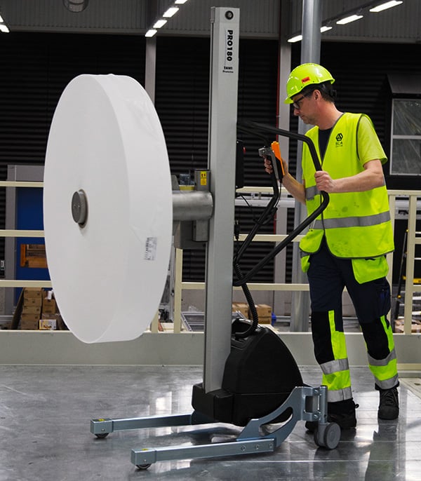 Man in packaging mounting reel with TAWI reel lifting trolleys