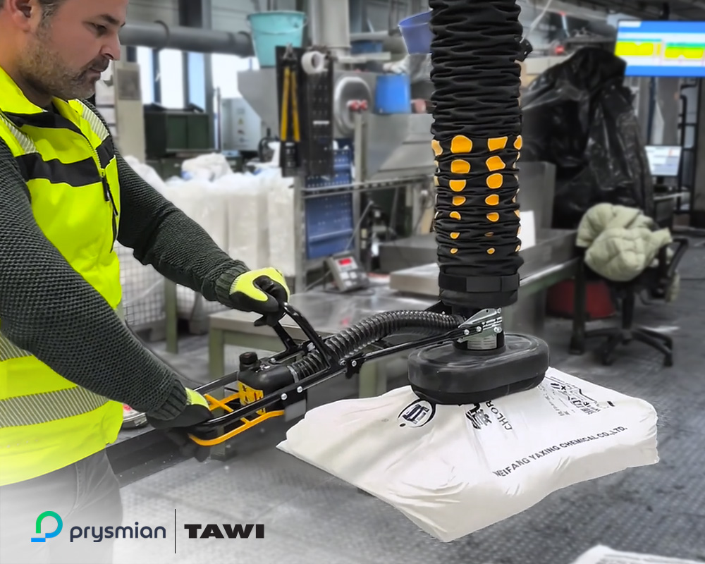 A person uses TAWI vacuum lifter to handle a sack.