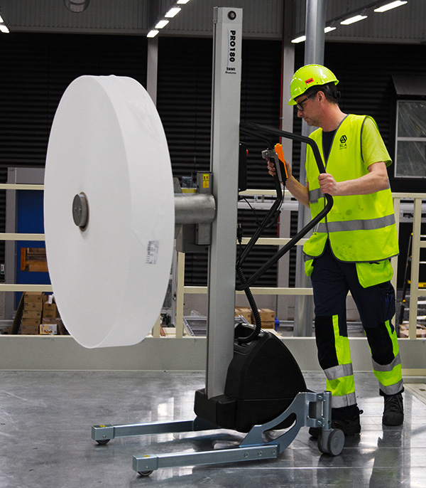 Man in packaging mounting reel with TAWI reel lifting trolleys