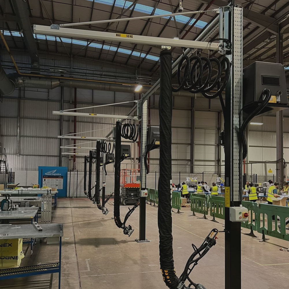 Vacuum crane systems installed in a busy warehouse to ease throughput