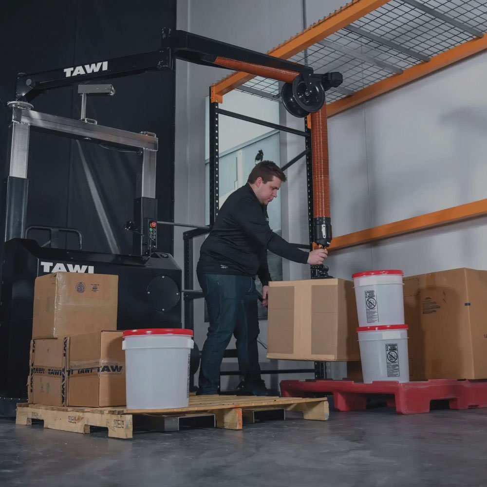 TAWI Mobile Vacuum Lifter moving items from shelving to a pallet