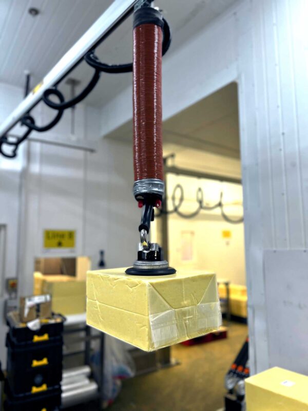 Lifting a block of cheese with a stainless vacuum lifter