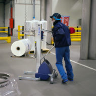 Man moving roll with lifting trolley