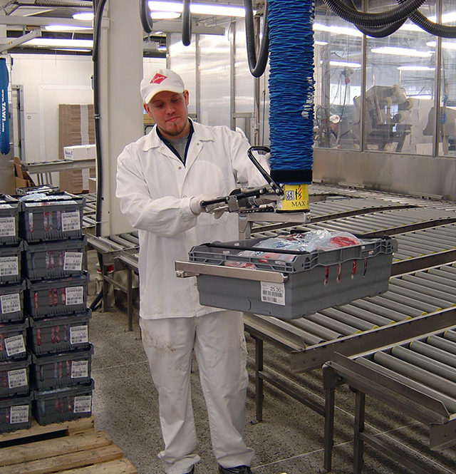 man lifting crate packed with meat