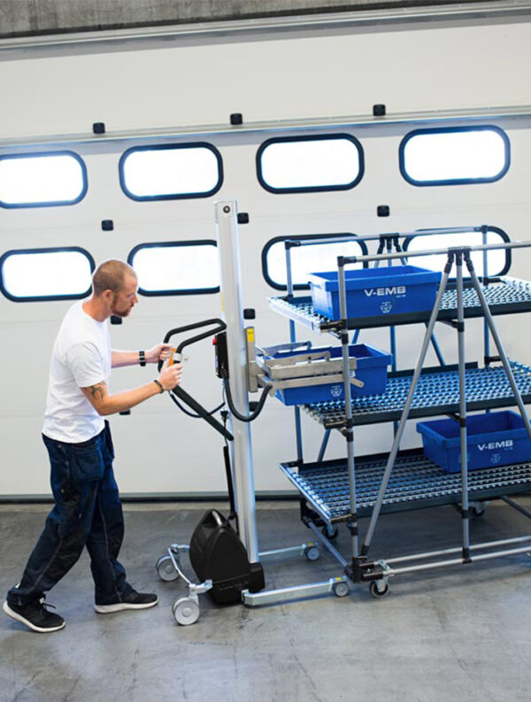 Man movig stacked trolley with boxes using a handhold vacuum lifter trolley