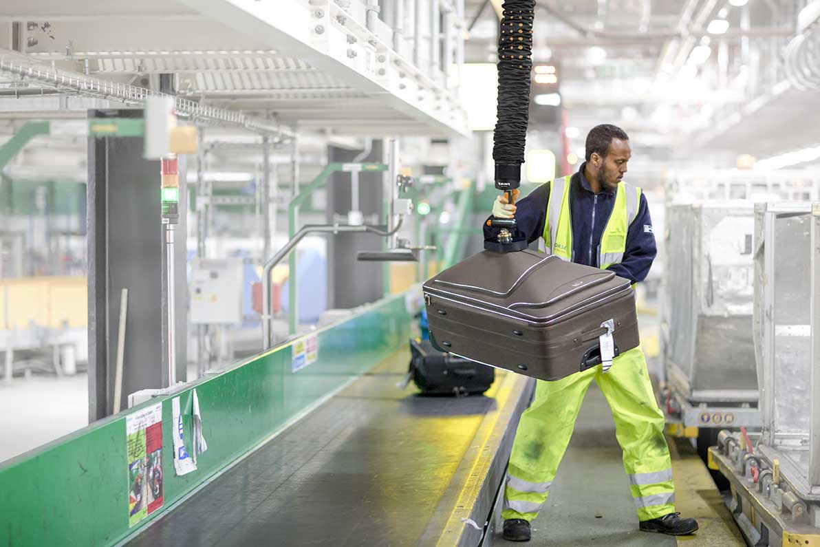 Lifting baggage at airport terminal