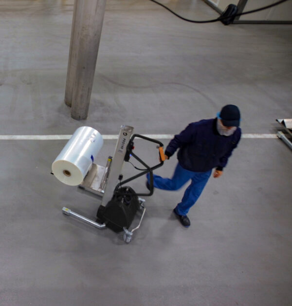 Man Lifting and moving plastic roll with lifting trolley